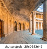 Masterful renaissance architecture among the remains of Charles V renaissance palace with a round central courtyard surrounded by a rectangular structure, the Alhambra, Granada, Andalusia, Spain