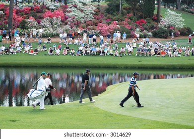 Masters.  Golfers and caddies at Augusta