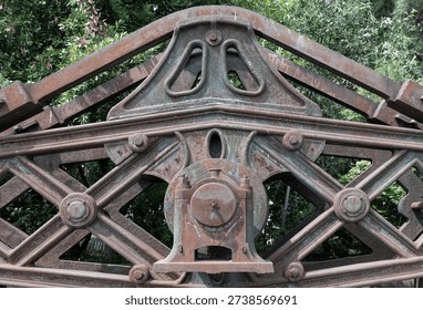 A masterwork of nineteenth-century engineering, this hollow-work cast-iron rocking beam—famously known as the 'Hammersmith beam'—displays a complex lattice of structural bracing once central to the Hammersmith Water Works. Now a centerpiece at the Kew Bridge Steam Museum in Brentford, its weathered, massive form serves as a silent, majestic echo of the Cornish steam engine it once powered.