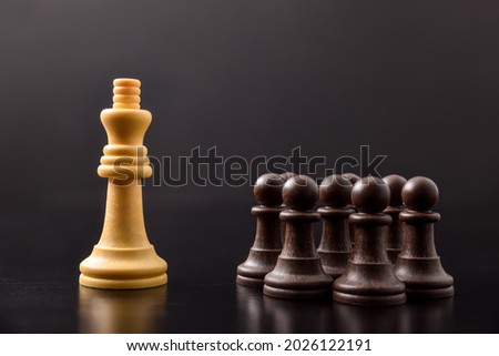 Mastery of power and crowd control and classes among men with concept with chess pieces on black table and background