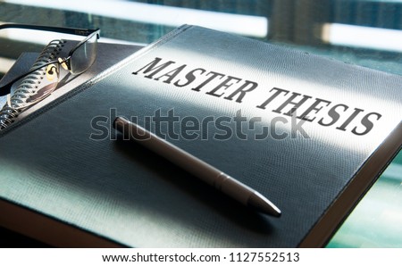 a mastest thesis in being written on desk