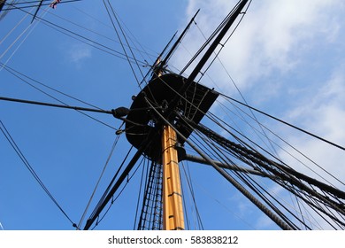 The Masts And Rigging Of A 19th Century British Frigate Against A Beautiful Blue Sky