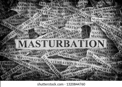 Masturbation. Torn pieces of paper with the words Masturbation. Concept image. Black and White. Close up.