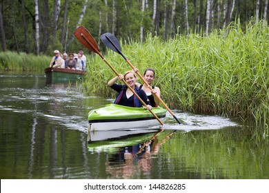 MASURIA, POLAND - JULY 13: Unidentified People Take Kayak Trip On Krutynia River On July 13, 2012 In Masurian Ditrict, Poalnd. More Than 5 Million Tourists Visit Masuria Every Year.