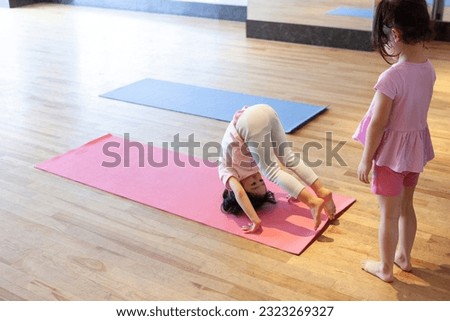 Mat exercise for small children. Forward roll.