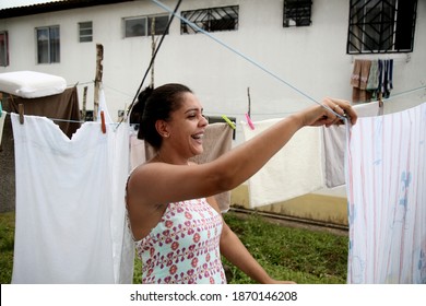 Mata De Sao Joao, Bahia, Brazil - October 1, 2020: Woman Holding Clothes Washed On A Clothesline In A Popular Neighborhood In The City Of Mata De Sao Joao. 