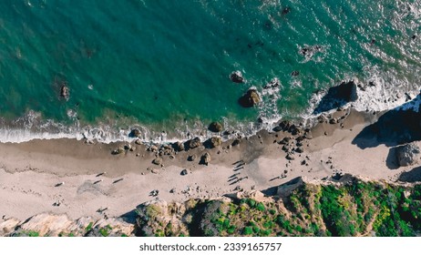 Matador beach and beautiful landscape with rocks and ocean against blue sky, California. An aerial shot of El Matador Beach in Malibu, California