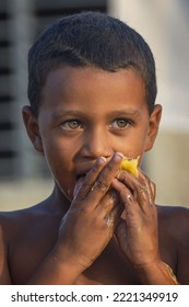 MATANZAS, CUBA - Jun 25, 2022: A Poor Cuban Boy Eating Mango