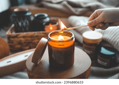 Match in hand lighting candles, aesthetics. - Powered by Shutterstock