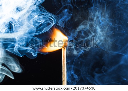 Match ignition. Puffs of smoke and flames