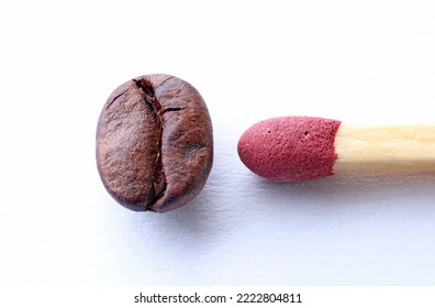 A match next to a roasted coffee bean