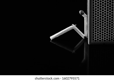 Match stick in thinking man style. Isolated black background. Match box. loneliness, sadness