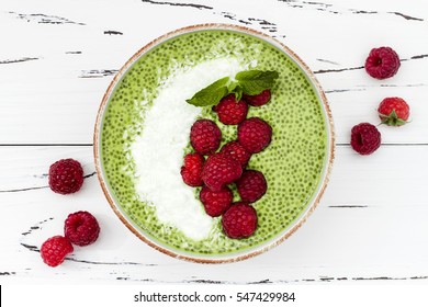 Matcha Green Tea Chia Seed Pudding Bowl, Vegan Dessert With Raspberry And Coconut Milk. Overhead, Top View, Flat Lay