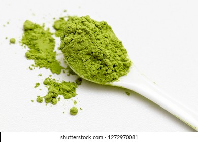 Matcha Green Tea Extract Powder And Teaspoon Isolated White Background