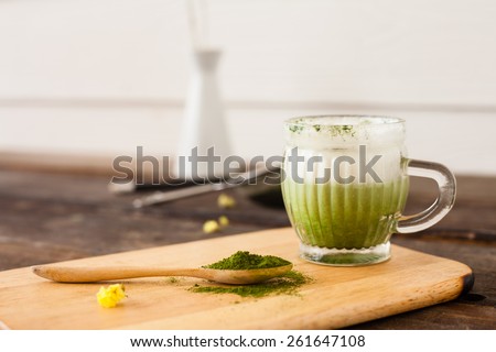 Matcha green tea latte beverage in glass mug  Selective Focus
