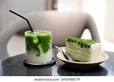 Matcha Green Tea sweet food and drinks products serve at cafe, Green crepe layer cake and iced latte green tea closeup on the table. - Powered by Shutterstock