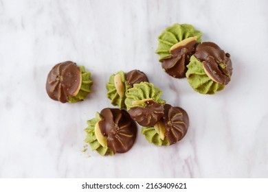 Matcha Greentea Cookies with Almond SLice and Dark Chocolated Coating, Top View on White Background
