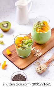 Matcha Overnight Oats With Kiwi And Peach Fruits, Chia Seeds In Glass. Healthy High Protein Breakfast On Terrazzo Table, Top View