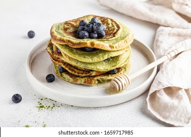 Matcha Pancakes On A White Background With Blueberries And Honey Vegan Food