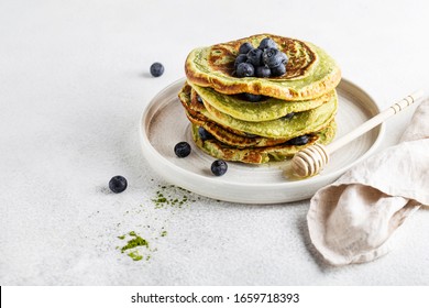 Matcha Pancakes On A White Background With Blueberries And Honey Vegan Food