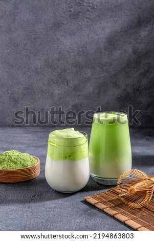 Matcha tea. Iced green tea matcha latte  in glass. Green tea dalgona, whipped grean tea with milk. Healthy vegan drink, close up.