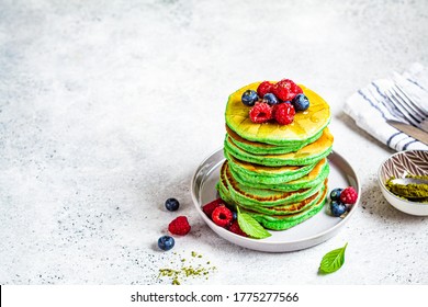 Matcha Tea Pancakes With Berries, White Background. Healthy Vegan Food Concept.