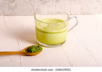 Matcha tea powder in wooden spoon. High quality photo