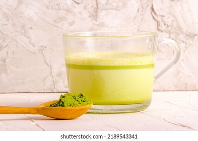 Matcha tea powder in wooden spoon. High quality photo