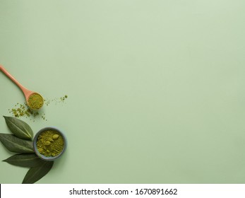 matcha tea with spoon and leaf on grean background. Concept healthy drink, copyspace, flatlay, top view.