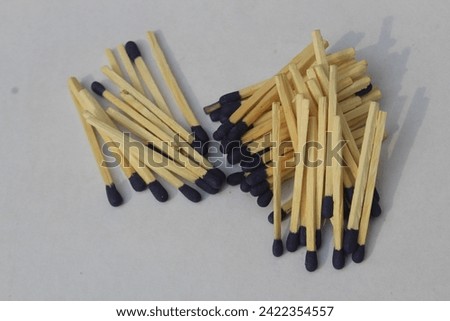 Matches in box, white background. Macro photography. Close-up shot. Matches in open match-box on carton underlay