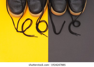 Matching Leather Sneakers With The Lettering LOVE Made Of The Laces On A Contrast Yellow And Brown Background. Romantic Concept Of Wearing Matching Outfits For Couples.