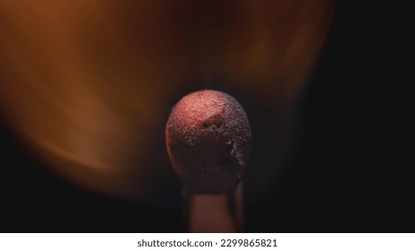 Matchstick with fire on the tip. Matchstick fires on Matchbox in macro slowmo. Macro Shot of Igniting Match against Black Background. Burning match, bright firelight - Powered by Shutterstock