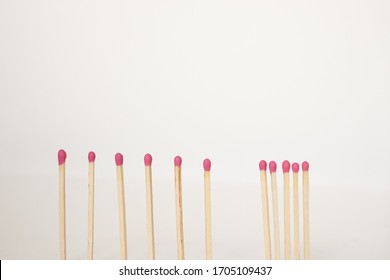 Matchsticks standing next to each other vs matchsticks staying apart on a white background. Social distancing concept