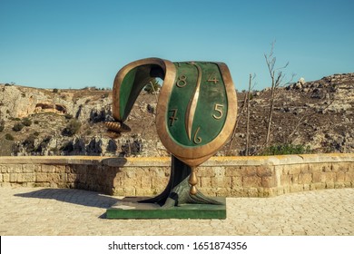 Matera, Italy - February 6, 2020: Sculpture Dali's melted clock displayed on the streets of Matera, Italy