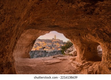 Matera, Italy as seen from within an ancient cave at dusk.