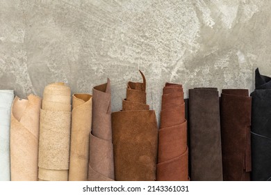 Material for creating handmade production at leather workshop. Selected pieces and bundle of beautiful colored or tanned craftman's work stuff lying inside of cupboard.  - Shutterstock ID 2143361031