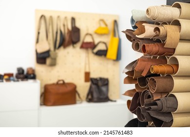 Material for creating handmade production at leather workshop. Selected pieces and bundle of beautiful colored or tanned craftman's work stuff lying inside of cupboard. Storage organization at tannery - Shutterstock ID 2145761483