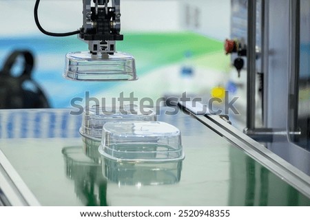 The material handling process by  robotic arm from injection machine. The food container box production process by plastic injection mold machine. 