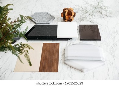 Material Sample Selections Including Granite Tile, Marble Tile, Acoustic Tile, Walnut And Ash Wood Laminate With Plant On Marble Top Table.