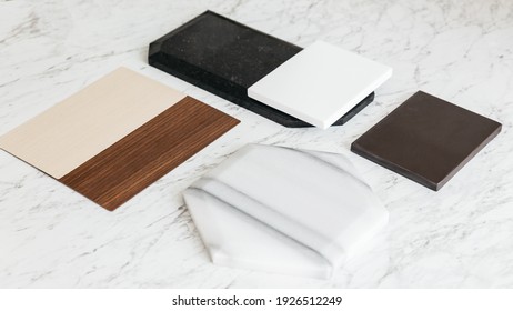 Material Sample Selections Including Granite Tile, Marble Tile, Acoustic Tile, Walnut And Ash Wood Laminate With Plant On Marble Top Table.