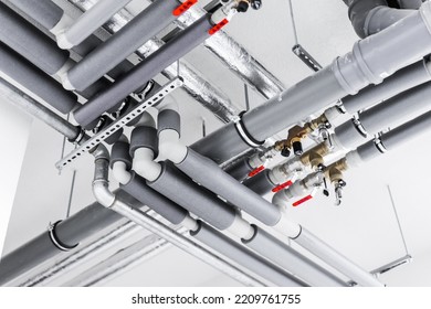 Materials for plumbing on a white wall background - Shutterstock ID 2209761755