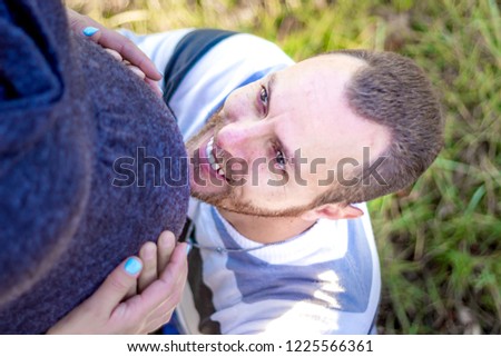 Maternity photo shoot, a father and pregnant mother in a gentle romantic embrace kissing, Cape Town, South Africa