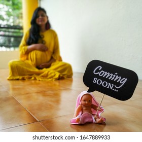 Maternity Photoshoot Of An Indian Woman With Props Of Baby Shower