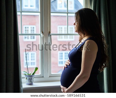 Maternity Portrait in front of window in UK                