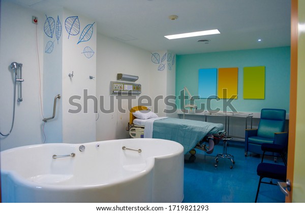 Maternity ward in a hospital with a bath for birth\
in water.