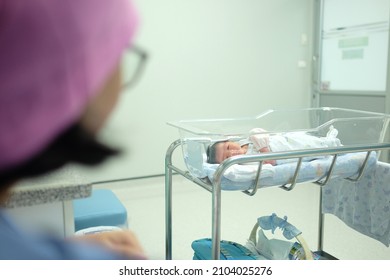 In Maternity Ward - Hospital, Mother Make Eye Contact With Her Newborn Sleep In Bassinet