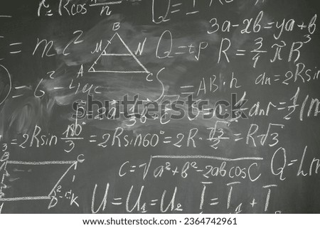 with math formulas written in white chalk on black board background