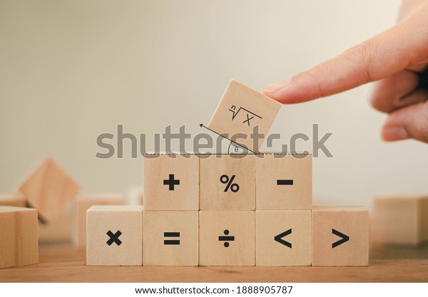 Math symbols written on the wooden\
blocks of a businessman With calculations with ideas A concept, a\
difficult problem or a mathematical\
solution