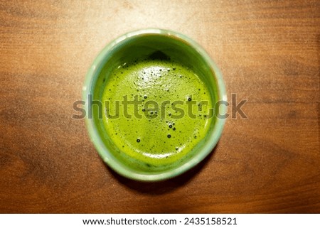A matha te in a ceramic cup on the bar
