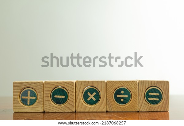 mathematic\
concept.,Mathematical operations or Plus, minus, multiply,\
divide,equal symbols on wooden onver white wall background with\
copyspace for put text or\
logo.